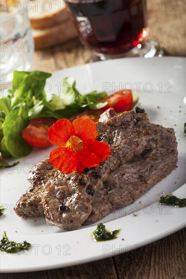 Grilled steak with nasturtium