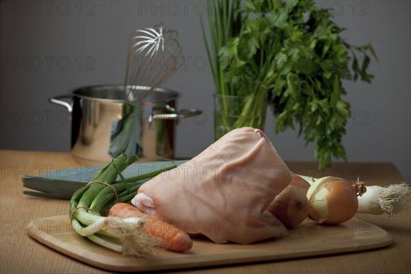 Raw knuckle of pork on a wooden table