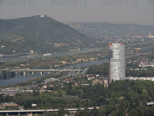City panorama with modern skyscraper and several rivers crossing the landscape, Vienna, Austria,