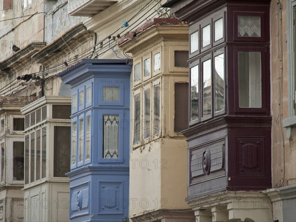 Colourful wooden balconies adorn historic buildings in an old town, valetta, mediterranean sea,