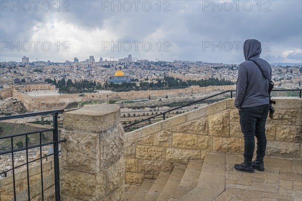 Young Israeli with machine gun overlooking Jerusalem Old City from Mount of Olives