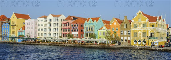 Panorama panoramic photo of landmark of Willemstad Curacao sunlit trading cade houses in colonial