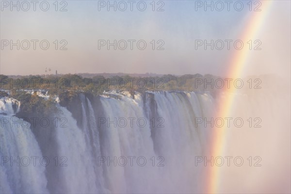 Close-up of the victoria falls in Zimbabwe, on a late afternoon with rainbow