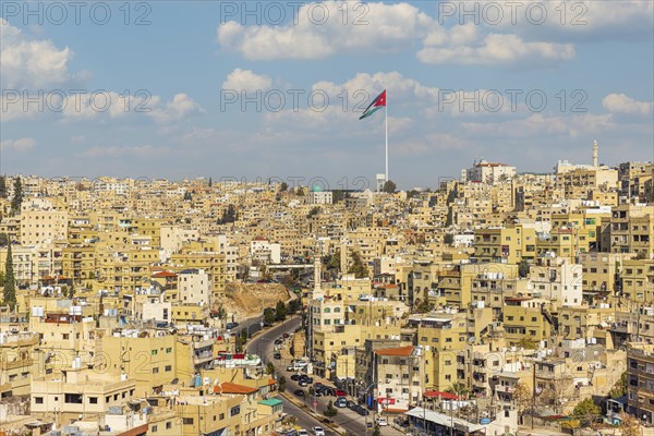 Jordan flag in Amman, panorama view of cloudy sky