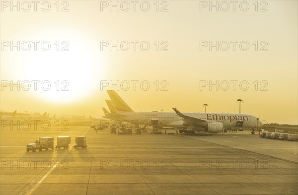 Sunset behind Ethiopian Airlines airplanes at Addis Ababa Bole International Airport ADD