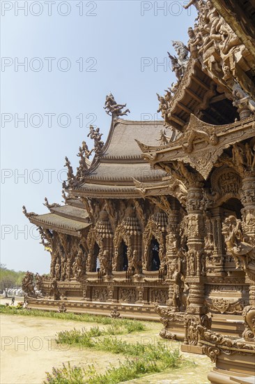 Detailed view of an ornate wooden temple, light and shadow effects on the structure, Pattaya,