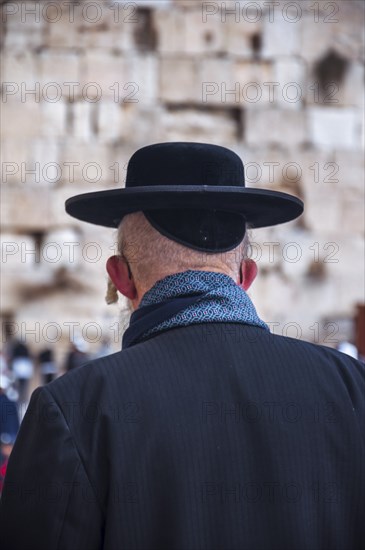 Religious orthodox jew from behind at the Western Wall in the old city of Jerusalem Israel