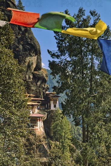 View of Taktshang Monastery through prayer flags