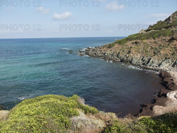 Seascape with rocky cliffs and green vegetation, ajaccio, corsica, france