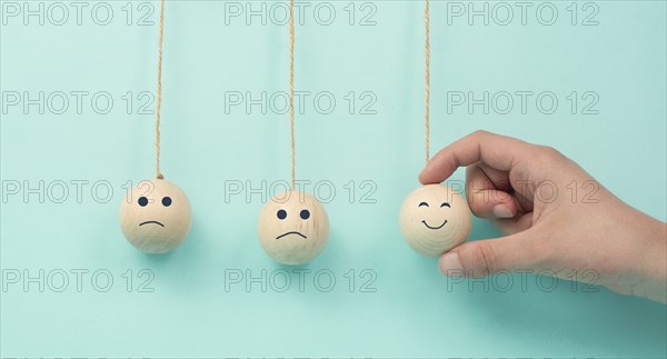 Happy smiling face spread happiness to sad faces, newton cradle concept, mental health and