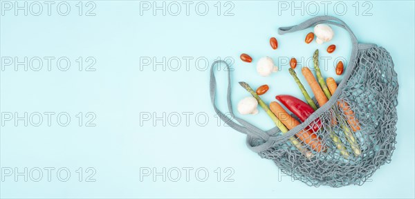 Asparagus sprout, mushrooms, carrots and tomatoes, zero waste, mesh bag with vegetables, shopping