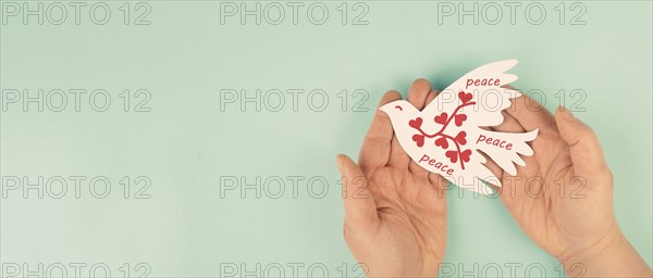 Dove with hearts flying from hand, international peace day, faith, freedom, charity and help