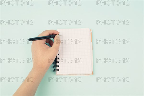 Left handers day, empty notebook, writing with the left hand, pen and table