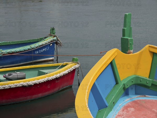 Multicoloured boats with bold colours docked in the water, marsaxlokk, mediterranean sea, malta