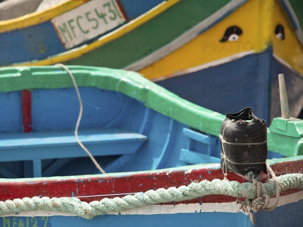 Detailed view of colourful boats docked at the harbour, marsaxlokk, mediterranean sea, malta