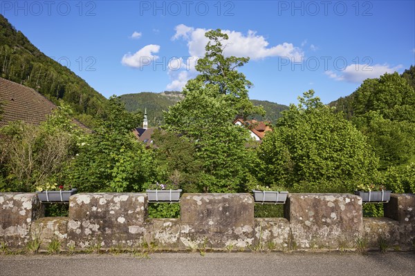 Old bridge with stone wall and flower boxes in the historic district of Geschwend, Todtnau, Black