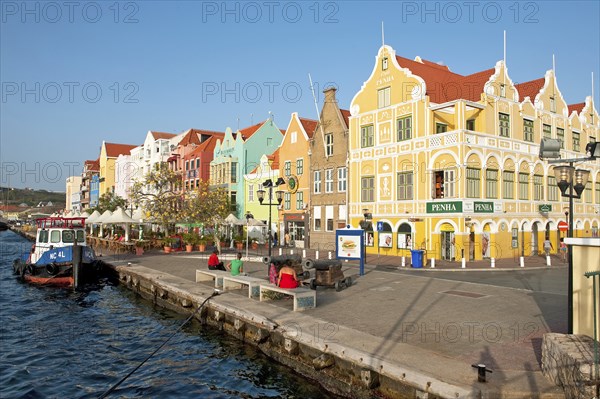 View of harbour promenade of Willemstad with landmark Handelskade houses in colonial style in Dutch