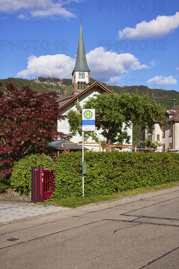 Church of St. Wendelin and bus stop in the centre of the historic district of Geschwend, Todtnau,