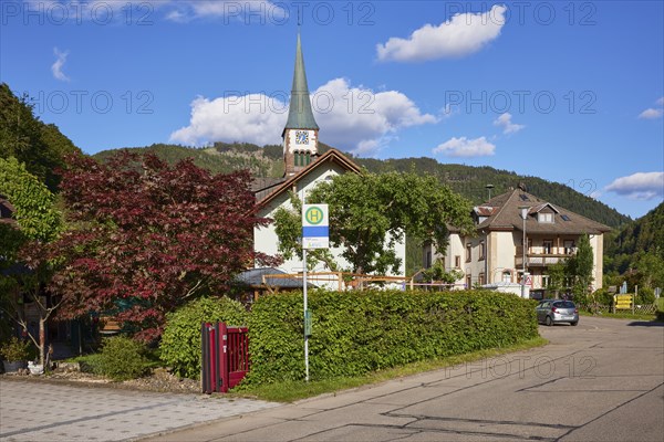 Church of St. Wendelin and bus stop in the centre of the historic district of Geschwend, Todtnau,