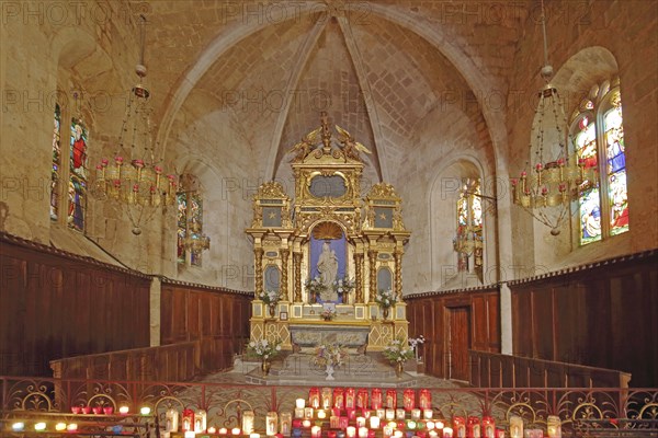 Interior view of the Gothic church Notre-Dame de Beauvoir high altar, candles, lights, church