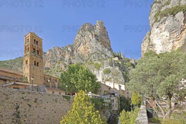 Church tower of Notre-Dame-de-l'Assomption and view to the rock, cliffs, summit, mountains,