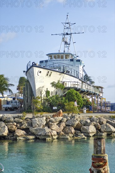 On small island accessible via short bridge installed on dry land at the entrance entrance area of