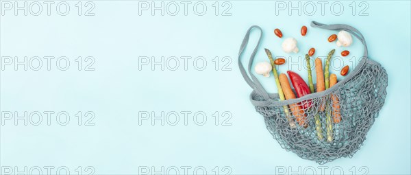 Mesh bag with vegetables, shopping grocery, healthy food ingredients, asparagus sprout, mushrooms,