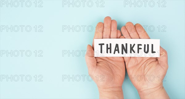 Thankful sign in hand, thank you, support, help and charity concept, positive attitude