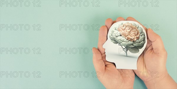 Hands holding head, human brain grows from tree, self care and mental health concept, positive