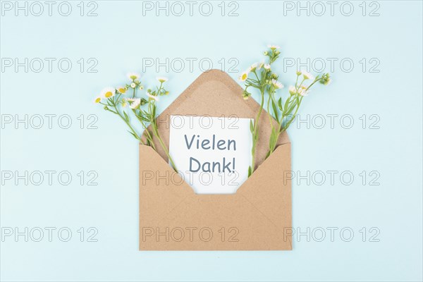 Thank you card, german language, envelope surrounded by spring flowers, being thankful, support,