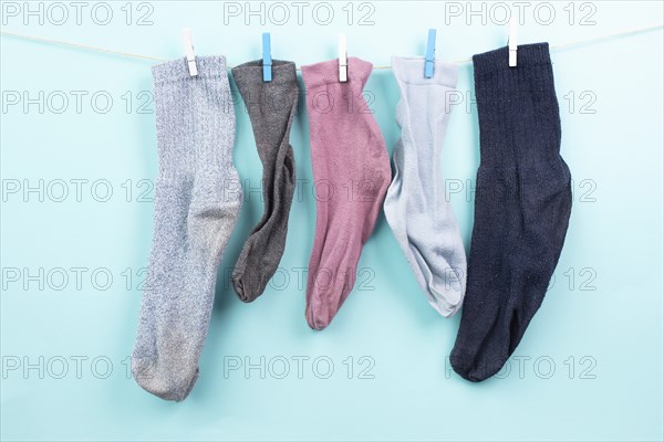 Lost socks hanging on a clothes line with clothespin, missing sock match after washing, memorial