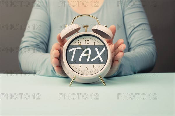Tax time, alarm clock for taxation, deadline for payment, financial income, return of taxes