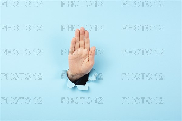 Hand waving, saying hello, friendly gesture, high five or stop sign, communication, torn paper hole