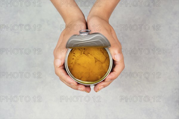 Open tin can with preserved food, box with tuna fish, processed ingredients, feeding a pet