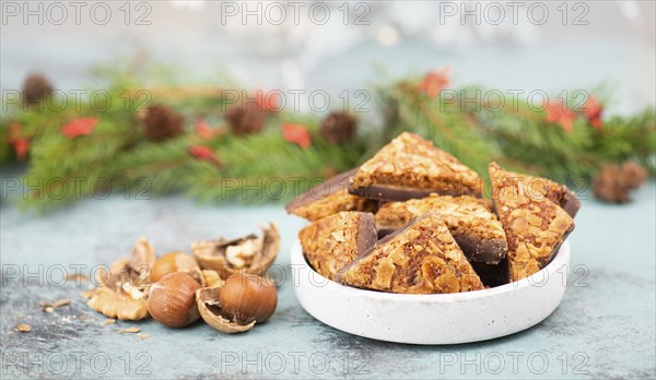 Nut corner triangles, traditional german sweets called Nussecke, covered with chocolate, christmas