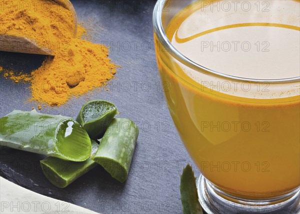 Drink aloe vera and turmeric. Glass cups on a slate tray