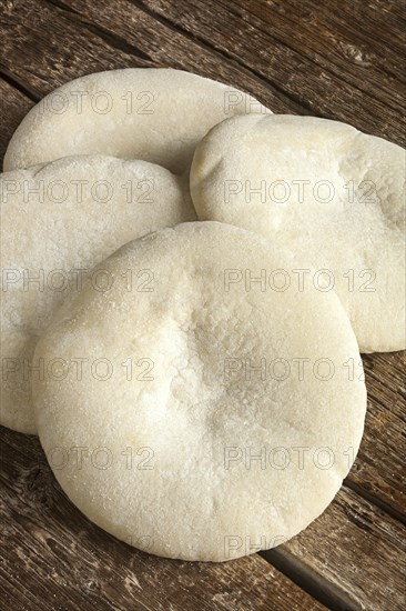 Four loaves of Arabic bread on the wooden table
