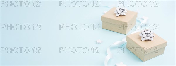 Christmas holiday greeting card with little gift boxes, stars and fir branches, blue background