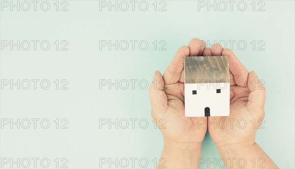 Hands holding house, buying or renting a home, real estate concept, investment in property,