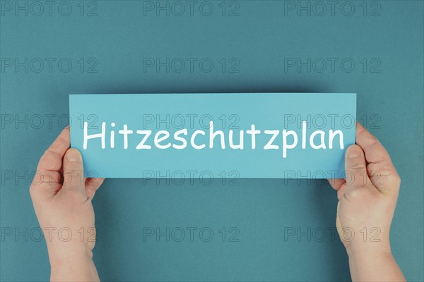 Heat protection plan stands in german language on the paper, regulation for warm summer days,
