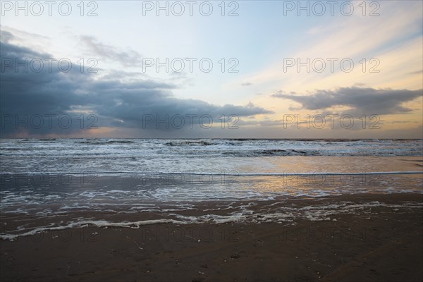 Wadden sea at low tide, North sea beach landscape, coast on Romo island in Denmark at sunset,