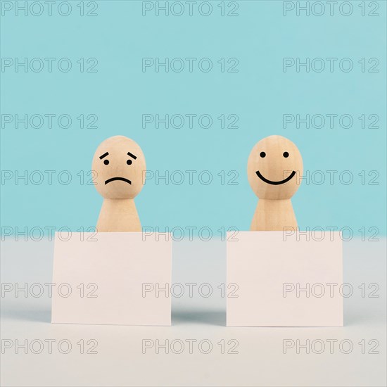 Man with a sad and a happy face holding empty signs, positive and negative mindset, support and