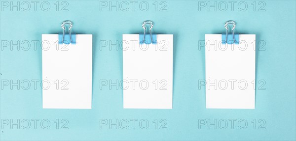 Blank white paper with a paperclip, reminder or message in the office, communication concept
