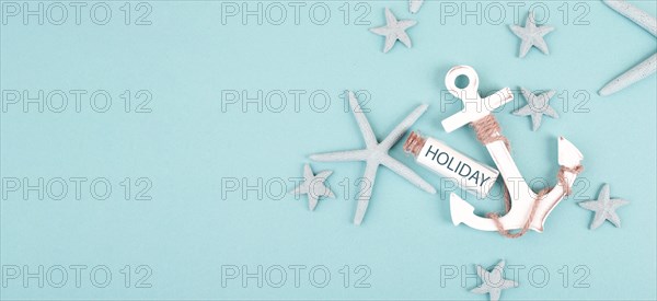 Summer vacation background, anchor, sea stars and a glass bootle with the word holiday, travel and