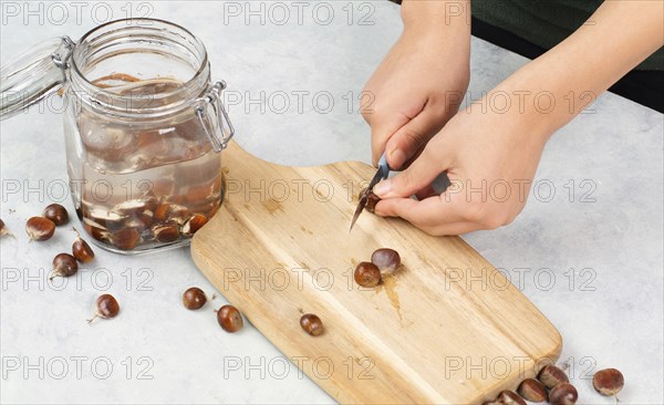 Preparing chestnut liquid soap, cutting buckeye and putting it into a jar with water, alternative