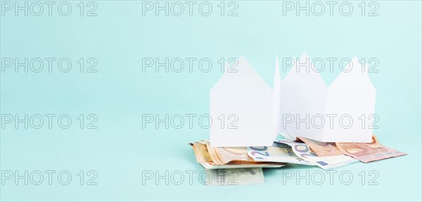 Paper house with Euro banknotes, planning to buy, build or rent a new home, real estate concept,