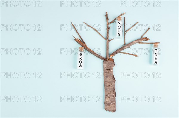 Grow your idea is standing on the bottles hanging on the tree, starting a new business, motivation