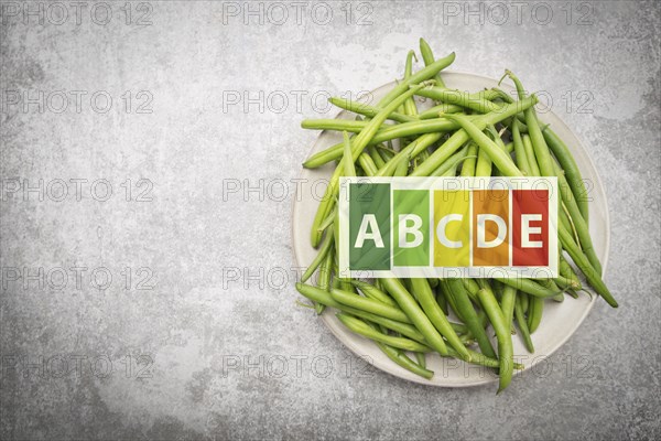 Green fresh string beans on a plate, vegetables, healthy food label, high nutritional values