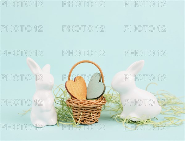 Wicker basket with hearts and an easter bunny, rabbit brings gift of love, greeting card for