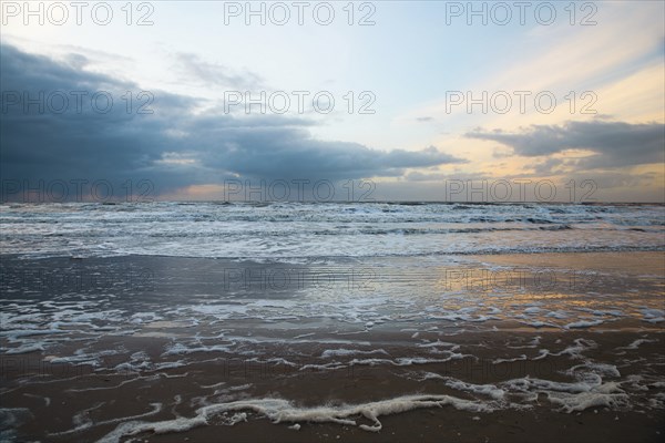 Wadden sea at low tide, North sea beach landscape, coast on Romo island in Denmark at sunset,